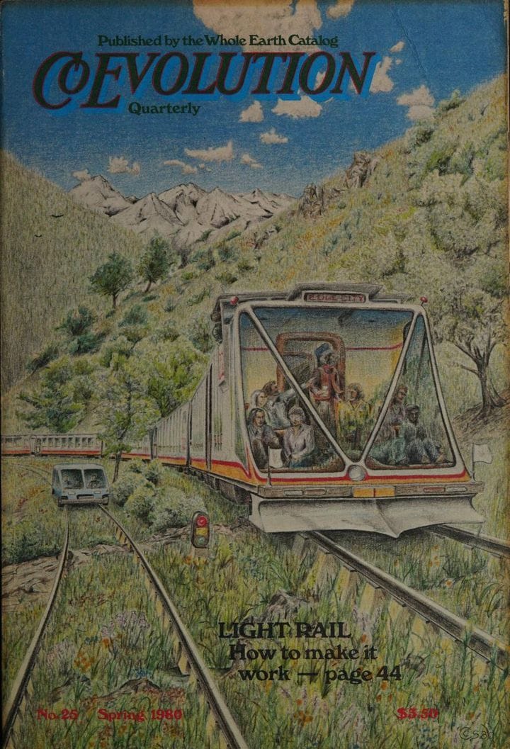 Commuters ride a light rail train through a green meadow, while a small railcar rides on another track nearby.