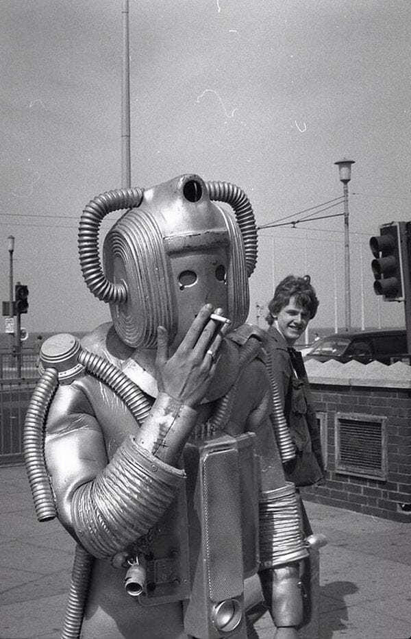 A cyberman from Doctor Who has a smoke.