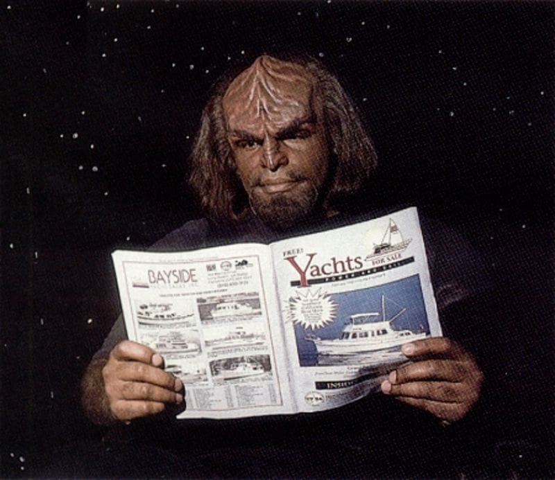 Michael Dorn reads 'Yachts' magazine while in costume as Worf from Star Trek.